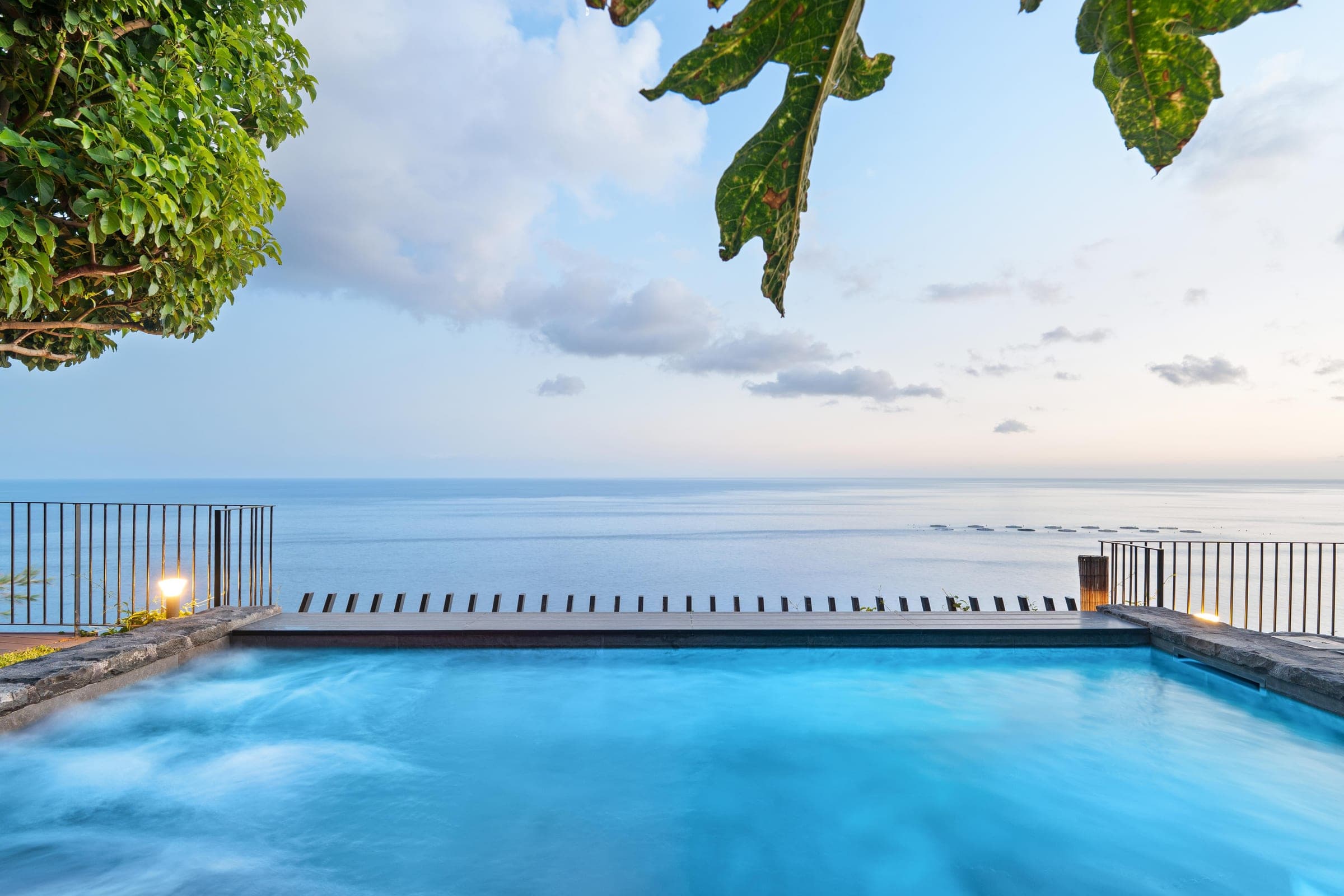Dusk. The pool's edge and the horizon become one line.